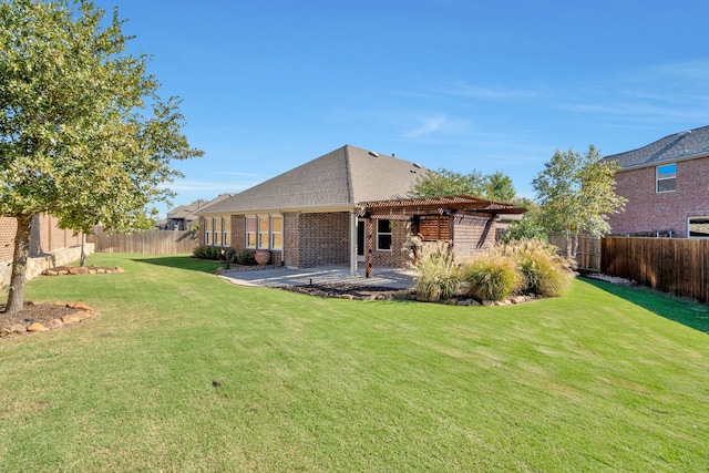 back of house with a pergola, a yard, and a patio