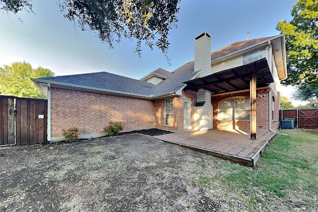 back of property featuring central AC unit and a patio