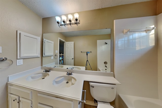 full bathroom featuring tiled shower / bath combo, toilet, a textured ceiling, and vanity