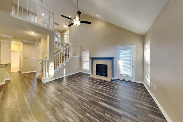 unfurnished living room featuring ceiling fan, wood-type flooring, a fireplace, and high vaulted ceiling