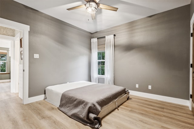 bedroom featuring light wood-type flooring and ceiling fan