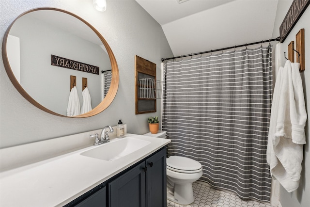 bathroom with tile patterned flooring, vanity, lofted ceiling, and toilet