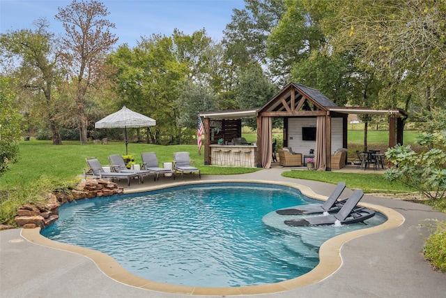 pool featuring a lawn, a gazebo, outdoor dry bar, and a patio area