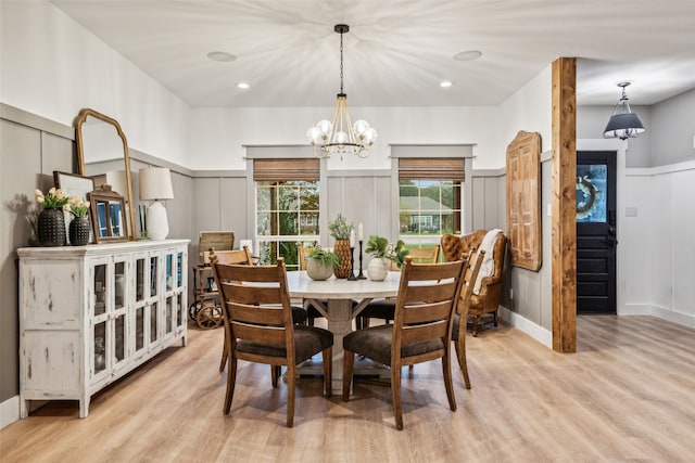 dining room featuring light hardwood / wood-style flooring and a notable chandelier