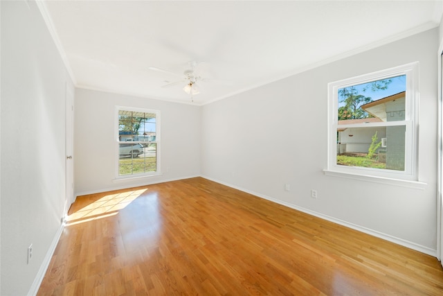 empty room with ceiling fan, light hardwood / wood-style flooring, and ornamental molding