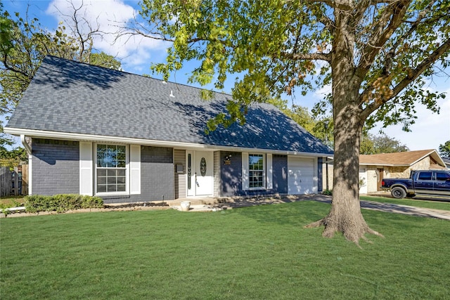 view of front of home featuring a garage and a front lawn