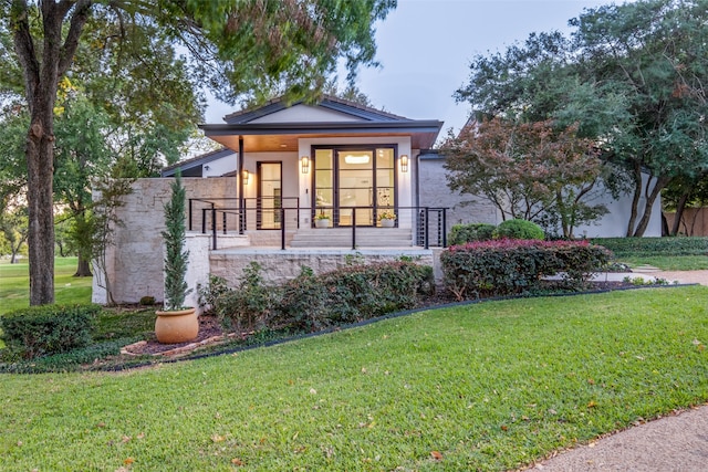 view of front of house with a front yard and a porch