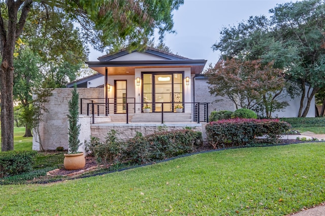 view of front of house with a front lawn and a porch