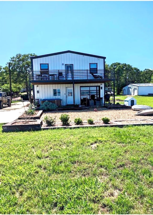 726 Lakeshore Dr, Kemp, TX 75143 - view of front of property with a front lawn, an outbuilding, a storage shed, board and batten siding, and a balcony