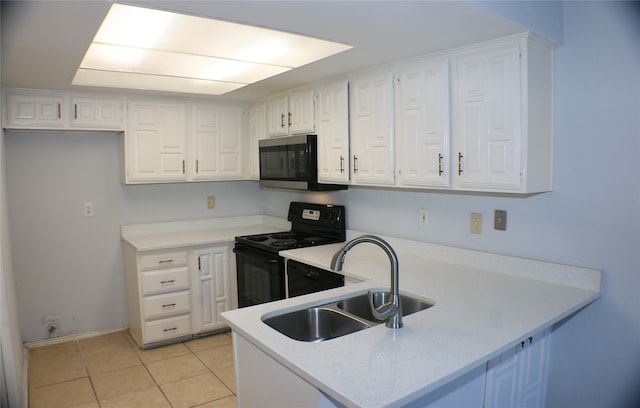 kitchen with electric range, white cabinets, light tile patterned floors, and sink