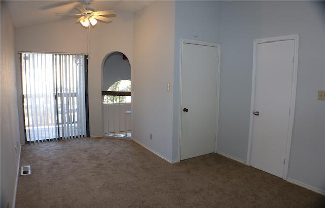 carpeted foyer featuring ceiling fan and vaulted ceiling