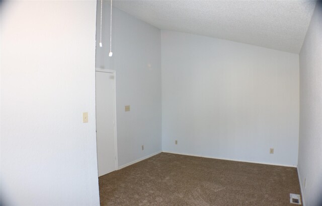 carpeted spare room featuring a textured ceiling