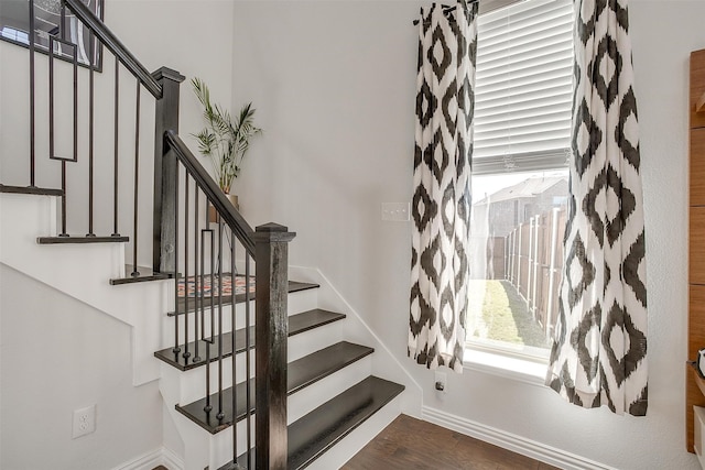 staircase with hardwood / wood-style floors