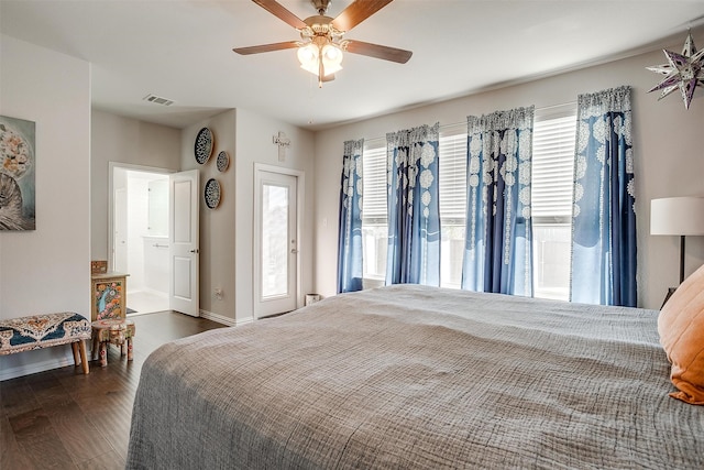 bedroom with ceiling fan, dark hardwood / wood-style flooring, and multiple windows