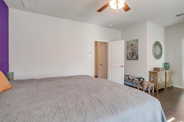 bedroom with dark hardwood / wood-style flooring and ceiling fan