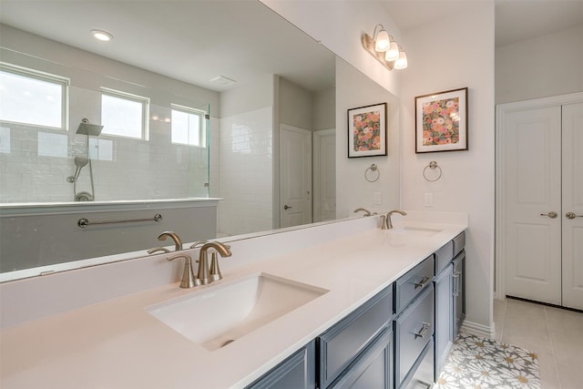 bathroom featuring tiled shower, vanity, and tile patterned floors