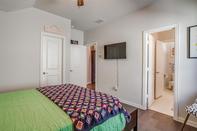 bedroom featuring ensuite bathroom, ceiling fan, lofted ceiling, and dark hardwood / wood-style floors