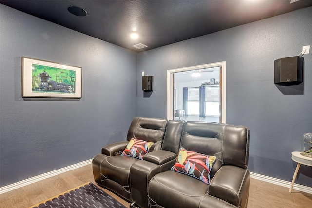 home theater room with light hardwood / wood-style floors