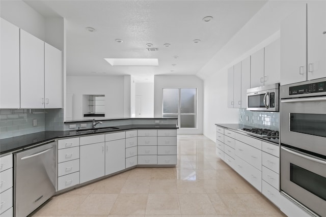 kitchen with white cabinetry, sink, and appliances with stainless steel finishes