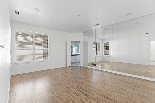 spare room featuring light wood-type flooring