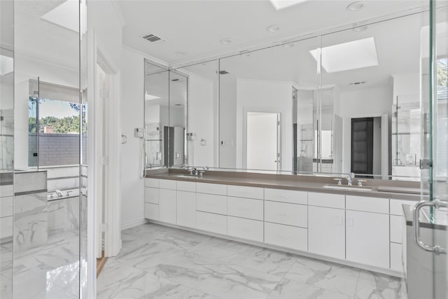 bathroom featuring vanity, an enclosed shower, crown molding, and a skylight