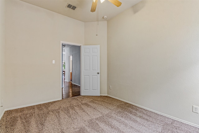 empty room featuring carpet flooring and ceiling fan