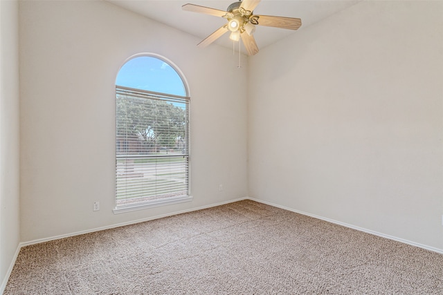 carpeted spare room with ceiling fan