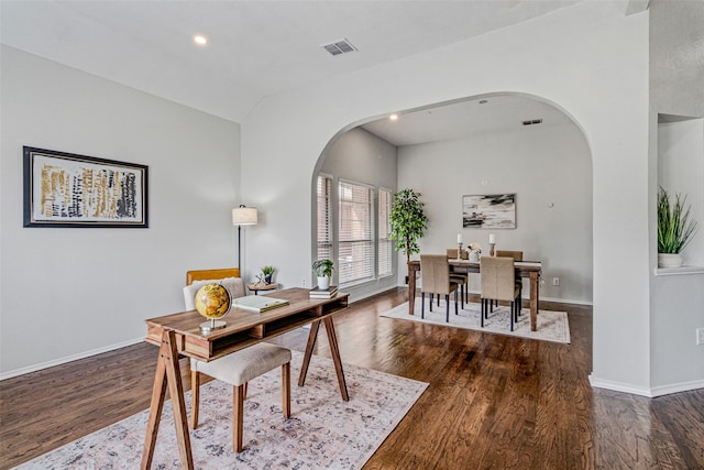 office with dark hardwood / wood-style floors and lofted ceiling