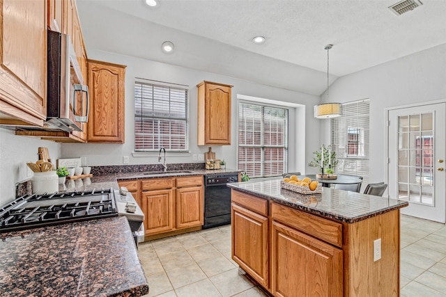 kitchen with decorative light fixtures, a center island, stainless steel appliances, and sink