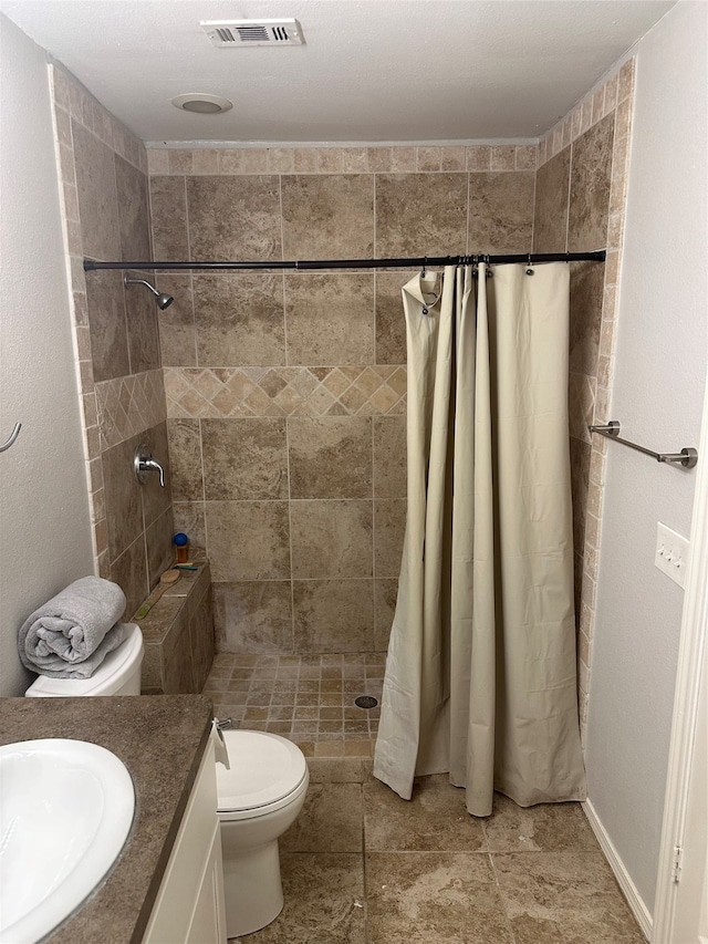 bathroom with vanity, toilet, and walk in shower