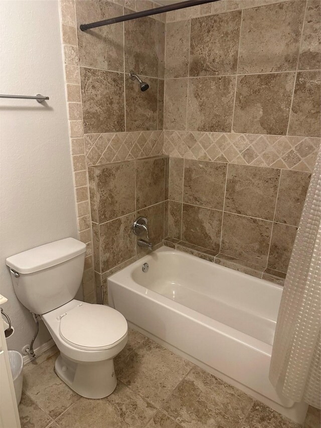 bathroom with shower / bath combo with shower curtain and toilet