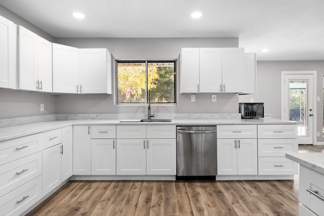 kitchen with white cabinetry, dark wood-type flooring, and stainless steel dishwasher