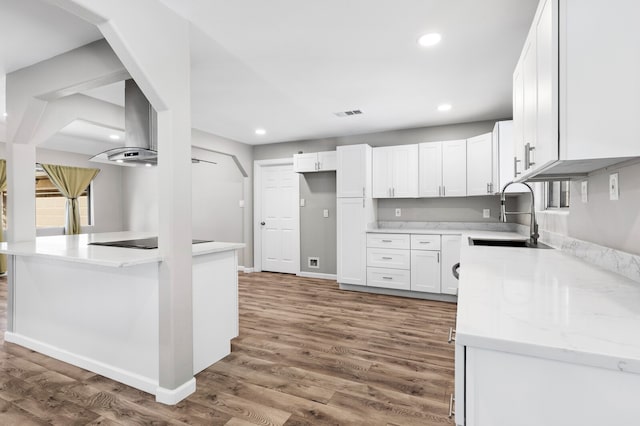 kitchen with white cabinetry, sink, light stone countertops, dark hardwood / wood-style flooring, and black electric stovetop