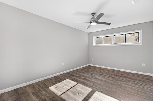 spare room featuring ceiling fan and dark hardwood / wood-style flooring