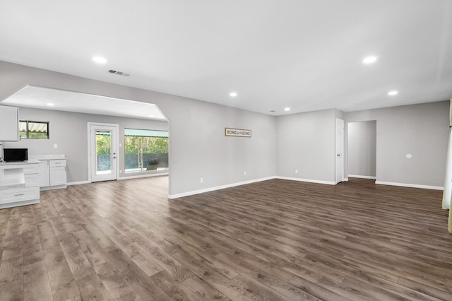 unfurnished living room featuring dark hardwood / wood-style floors