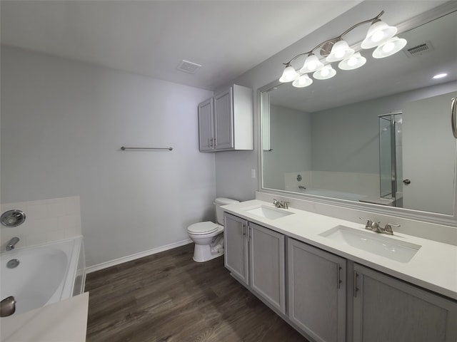 bathroom featuring a bathtub, toilet, wood-type flooring, and vanity