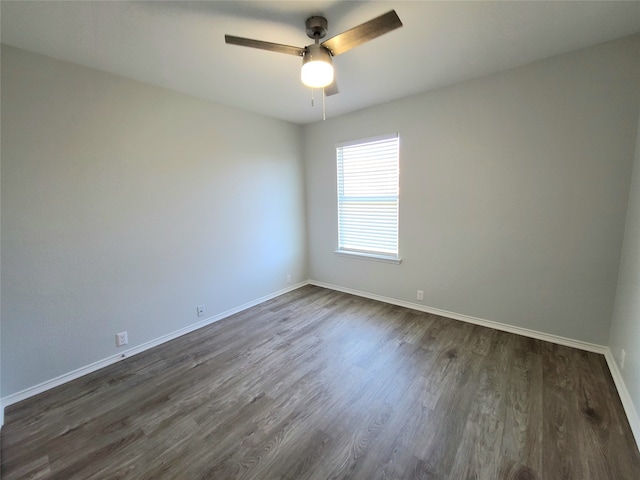 empty room featuring ceiling fan and dark wood-type flooring