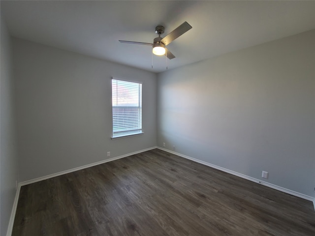 unfurnished room with ceiling fan and dark wood-type flooring