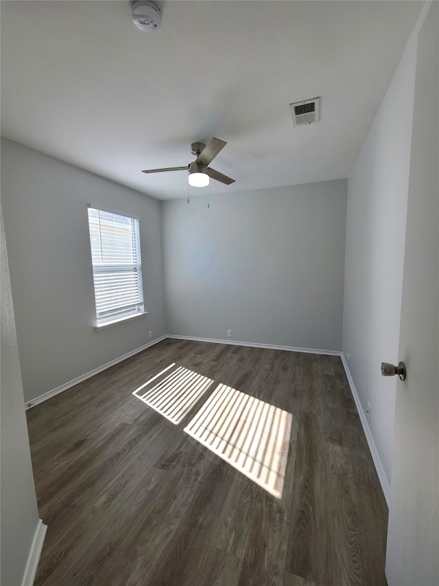 empty room featuring ceiling fan and dark wood-type flooring