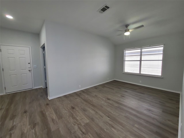 spare room with ceiling fan and dark wood-type flooring