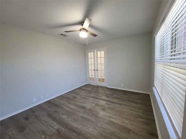 spare room with ceiling fan, french doors, and dark hardwood / wood-style floors