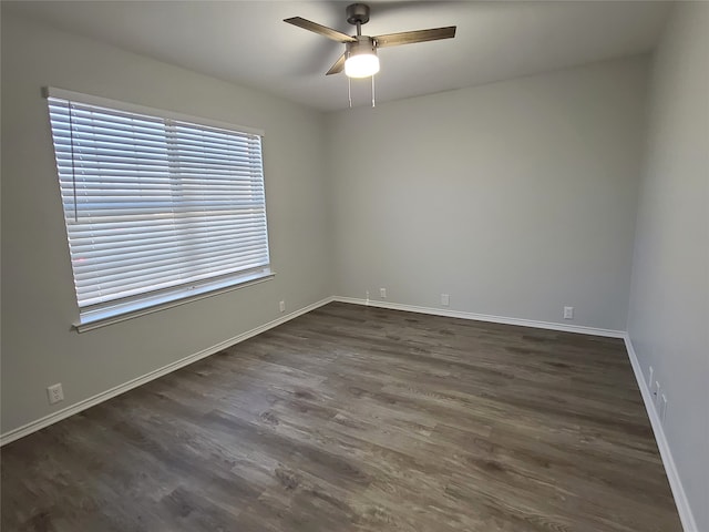 unfurnished room with ceiling fan and dark hardwood / wood-style flooring