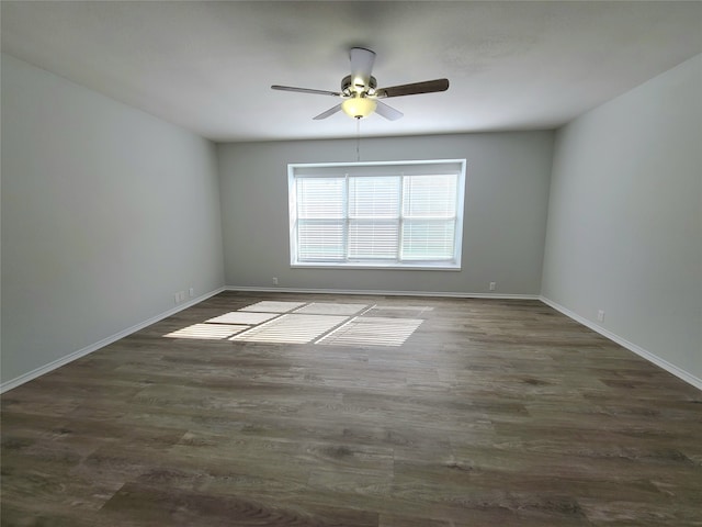 spare room with ceiling fan and dark hardwood / wood-style flooring