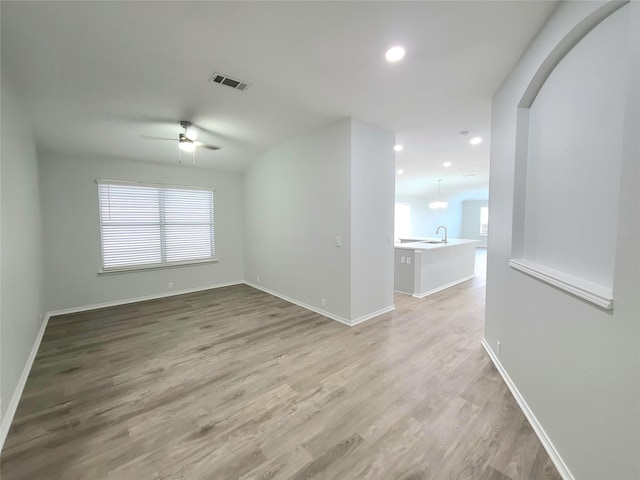 spare room featuring ceiling fan and light hardwood / wood-style floors