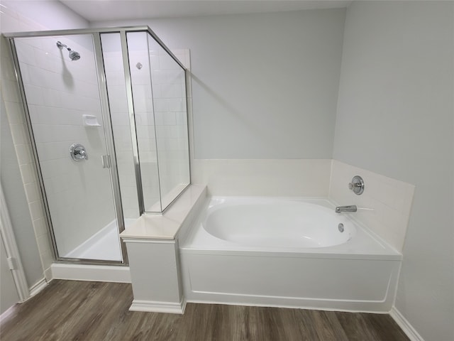 bathroom featuring independent shower and bath and wood-type flooring