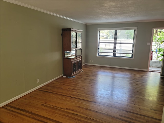 unfurnished living room featuring plenty of natural light, dark hardwood / wood-style flooring, and ornamental molding