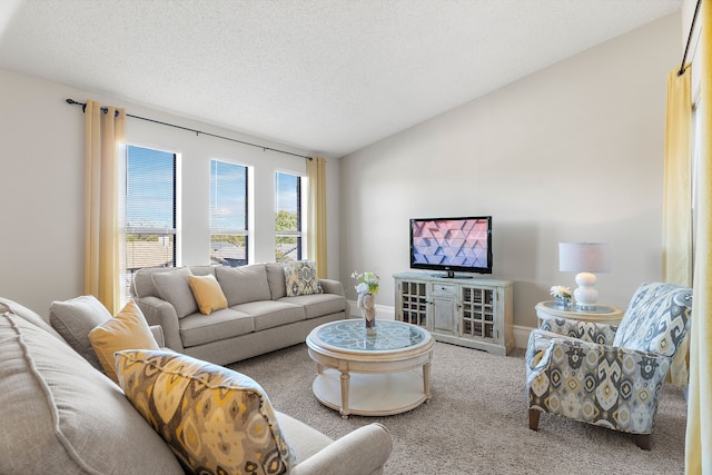 living room with a textured ceiling, carpet floors, and lofted ceiling