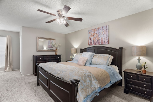 bedroom featuring ceiling fan, light carpet, and a textured ceiling