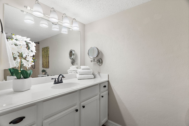 bathroom featuring vanity and a textured ceiling