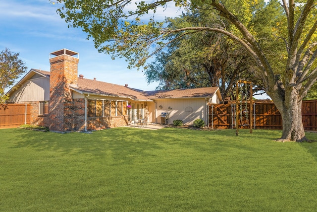 back of property with a patio area and a yard